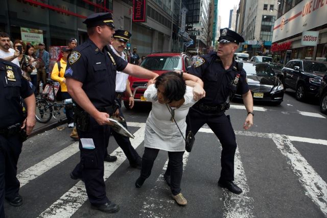 Chaumtoli Huq being restrained by NYPD police officers on a street in Times Square (picture courtesy of Chaumtoli Huq)